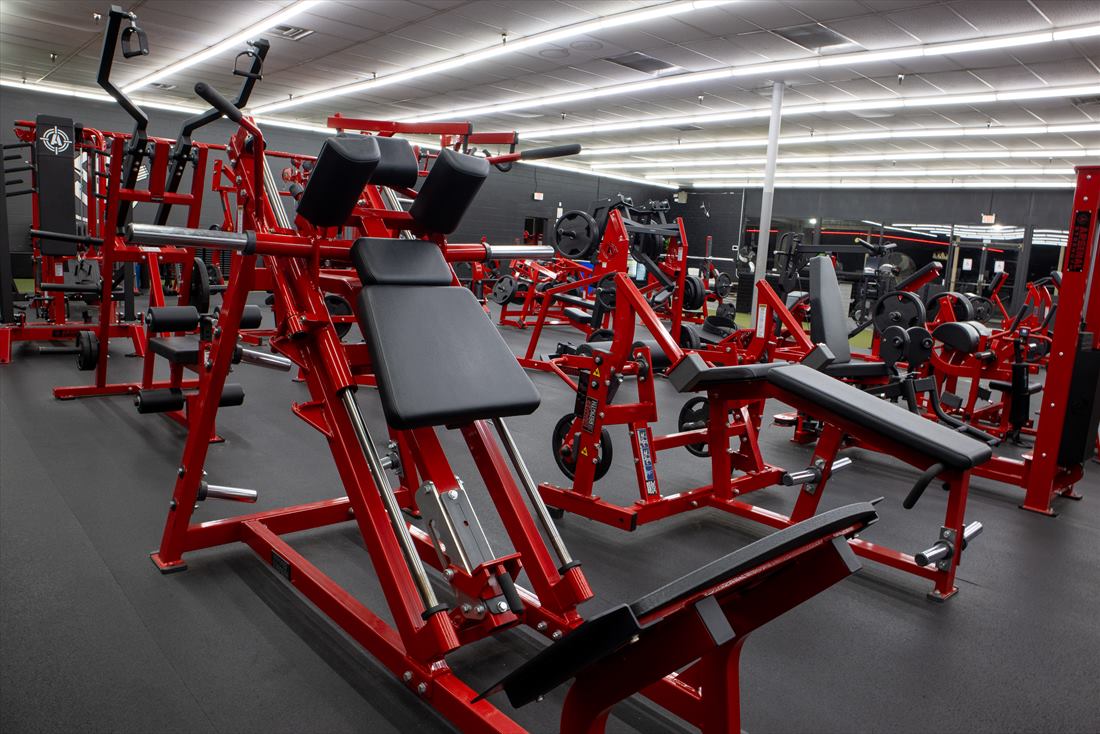 Red strength machines on the gym floor